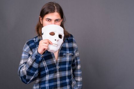 Young handsome hipster man with long hairの写真素材