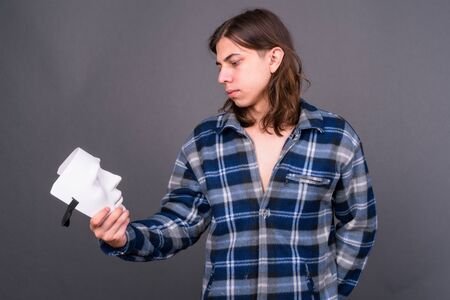 Young handsome hipster man with long hairの写真素材