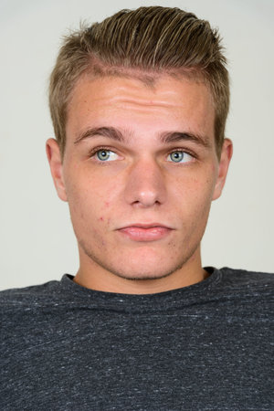 Face of young handsome man with blond hair thinking