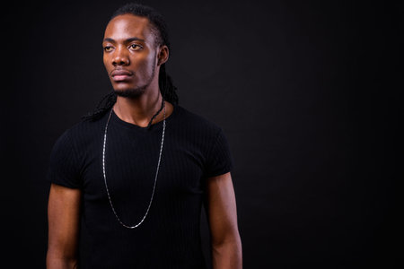Portrait of young handsome African man with dreadlocks