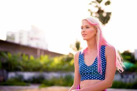 Young beautiful blonde woman in the streets outdoors