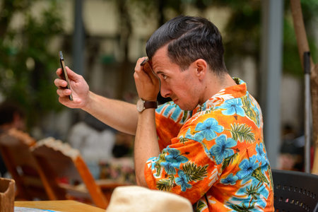 Young handsome tourist man sitting at the restaurant