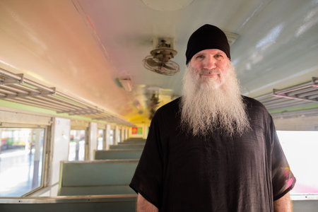 Mature handsome bearded tourist man inside the trainの写真素材