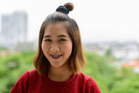 Portrait of young Asian woman with short hair outdoorsの写真素材