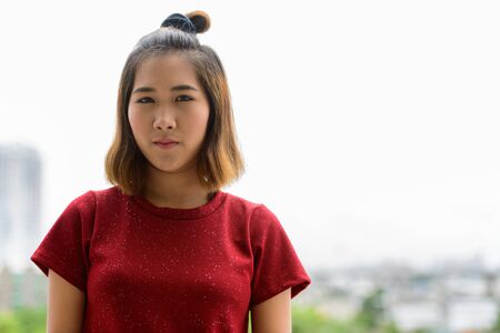 Portrait of young Asian woman with short hair outdoorsの写真素材