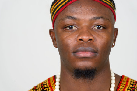 Face of young handsome African man wearing traditional clothing