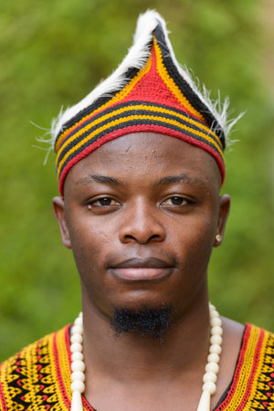 Face of young handsome African man wearing traditional clothing outdoorsの写真素材