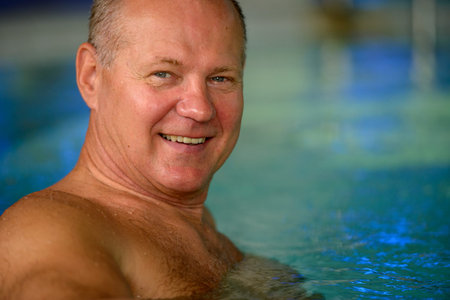 Face of happy senior tourist man relaxing at the spa
