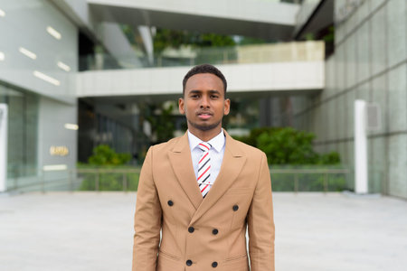 Young handsome African businessman wearing suit in the city outdoorsの写真素材