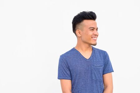 Face of happy young handsome multi ethnic man thinking against whiteの写真素材