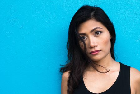 Face of young beautiful Asian woman outdoorsの写真素材