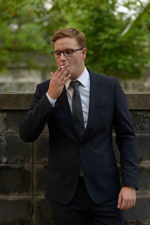 Businessman with blond hair in the streets outdoorsの写真素材