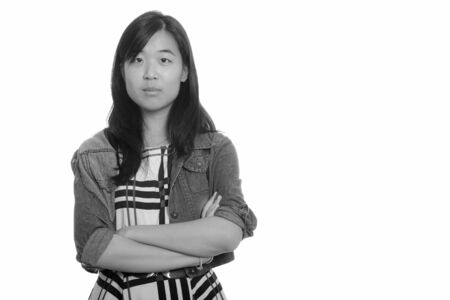 Portrait of young beautiful Asian businesswoman with arms crossedの写真素材