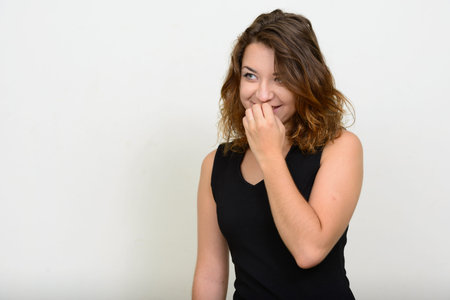 Portrait of happy young beautiful woman thinking and laughing