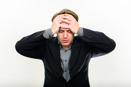 Portrait of stressed young businessman getting bad news