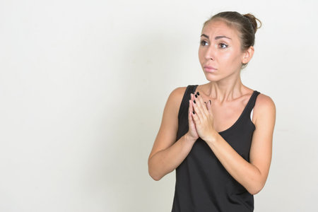 Young woman with brown hair praying and pleading