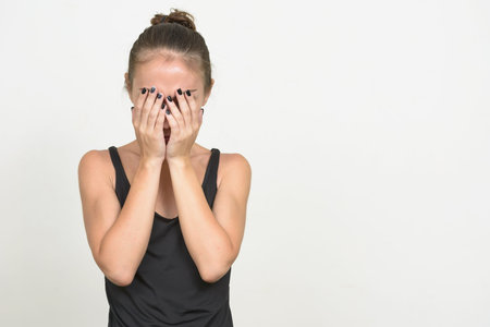 Stressed young woman with brown hair looking sad and crying