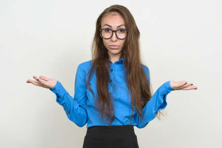 Portrait of young businesswoman with eyeglasses shrugging shouldersの写真素材