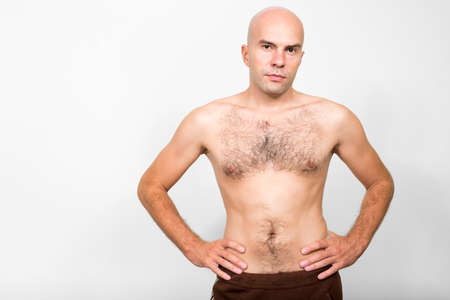 Portrait of bald man shirtless with hair on chestの写真素材