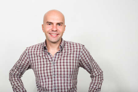 Portrait of happy bald businessman smiling and looking at cameraの写真素材