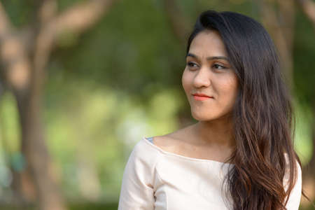 Face of Asian businesswoman thinking at the parkの写真素材