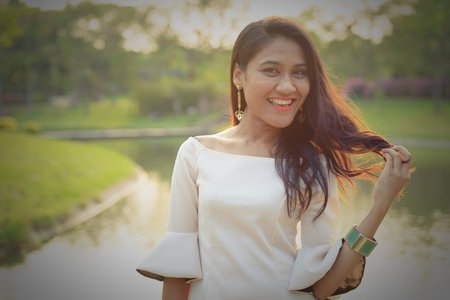 Happy Asian businesswoman smiling at the parkの写真素材