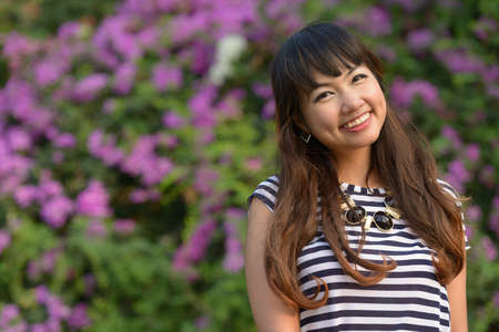 Happy young beautiful Asian woman smiling at the parkの写真素材