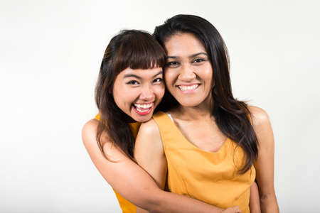 Portrait of two happy young Asian women togetherの写真素材