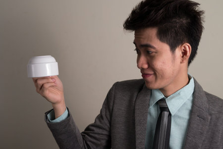 Portrait of young handsome Asian businessman