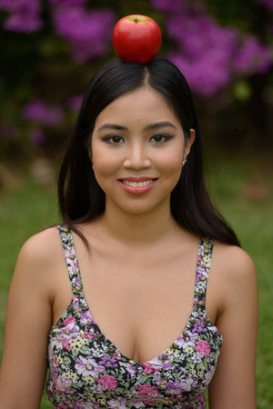 Portrait of young beautiful Asian woman at the park outdoors