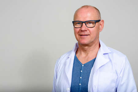 Portrait of mature handsome man doctor with eyeglassesの写真素材