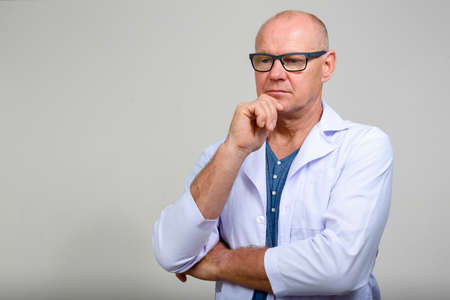 Portrait of mature handsome man doctor with eyeglassesの写真素材