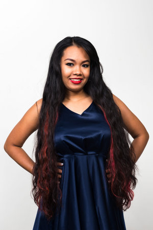 Portrait of young Asian woman against white background