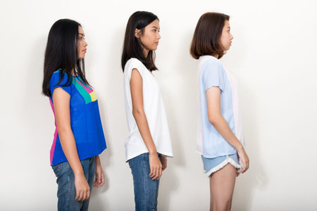Portrait of three young beautiful Asian teenage girls as friends together