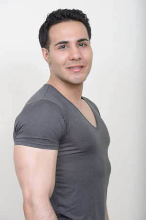 Portrait of young handsome man against white background