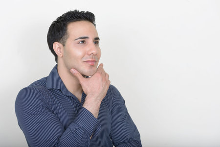 Portrait of young handsome businessman against white background
