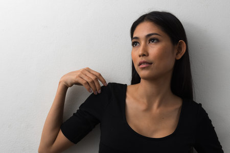 Portrait of young beautiful Asian businesswoman against white background