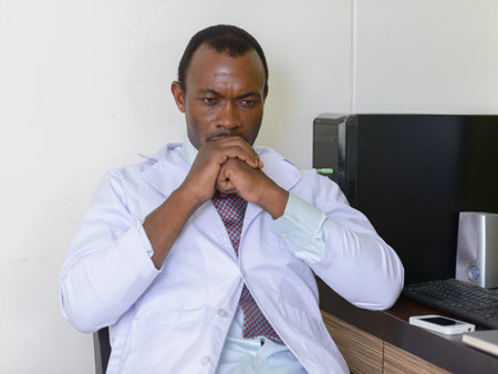 Handsome bearded African man doctor working in the office