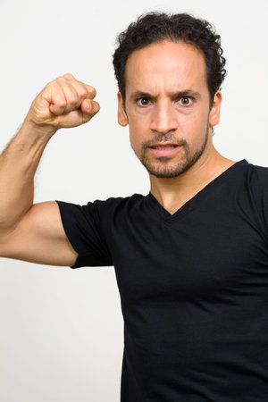 Portrait of handsome bearded Hispanic man with curly hair