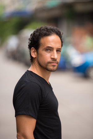 Handsome bearded Hispanic man in the streets outdoors
