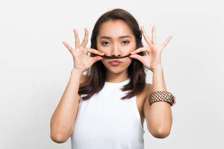 Studio shot of young beautiful Asian womanの写真素材