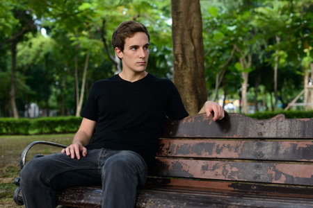 Portrait of young handsome man at the park