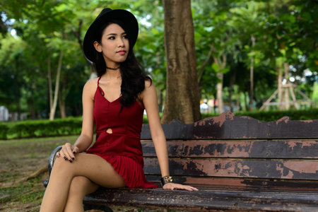 Portrait of young beautiful Asian woman at the park