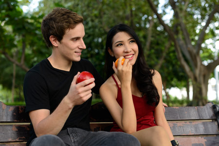 Portrait of multi ethnic couple together and in love at the park