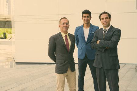Portrait of Persian businessmen together in the city streets outdoors