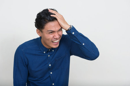 Portrait of happy handsome Asian businessman smiling