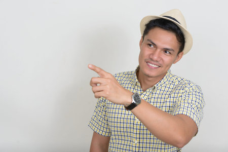 Portrait of happy handsome Asian tourist man smiling