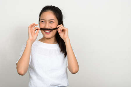 Portrait of happy young beautiful Asian womanの写真素材