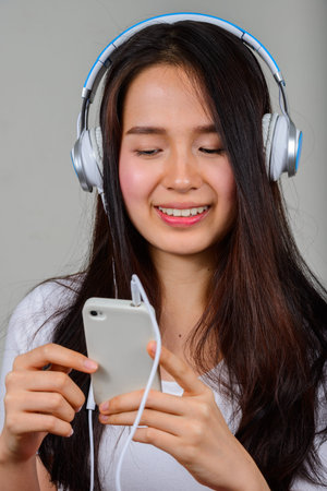 Portrait of happy young beautiful Asian woman