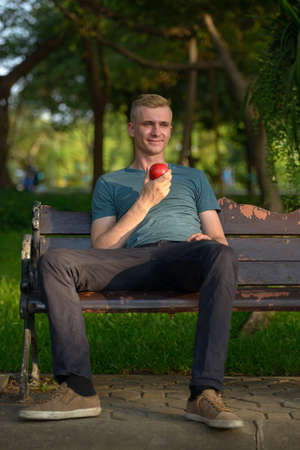 Young man with blond hair at the park outdoorsの写真素材